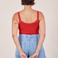 Back view of Cropped Cami in Mustang Red and light wash Sailor Jeans worn by Tiara