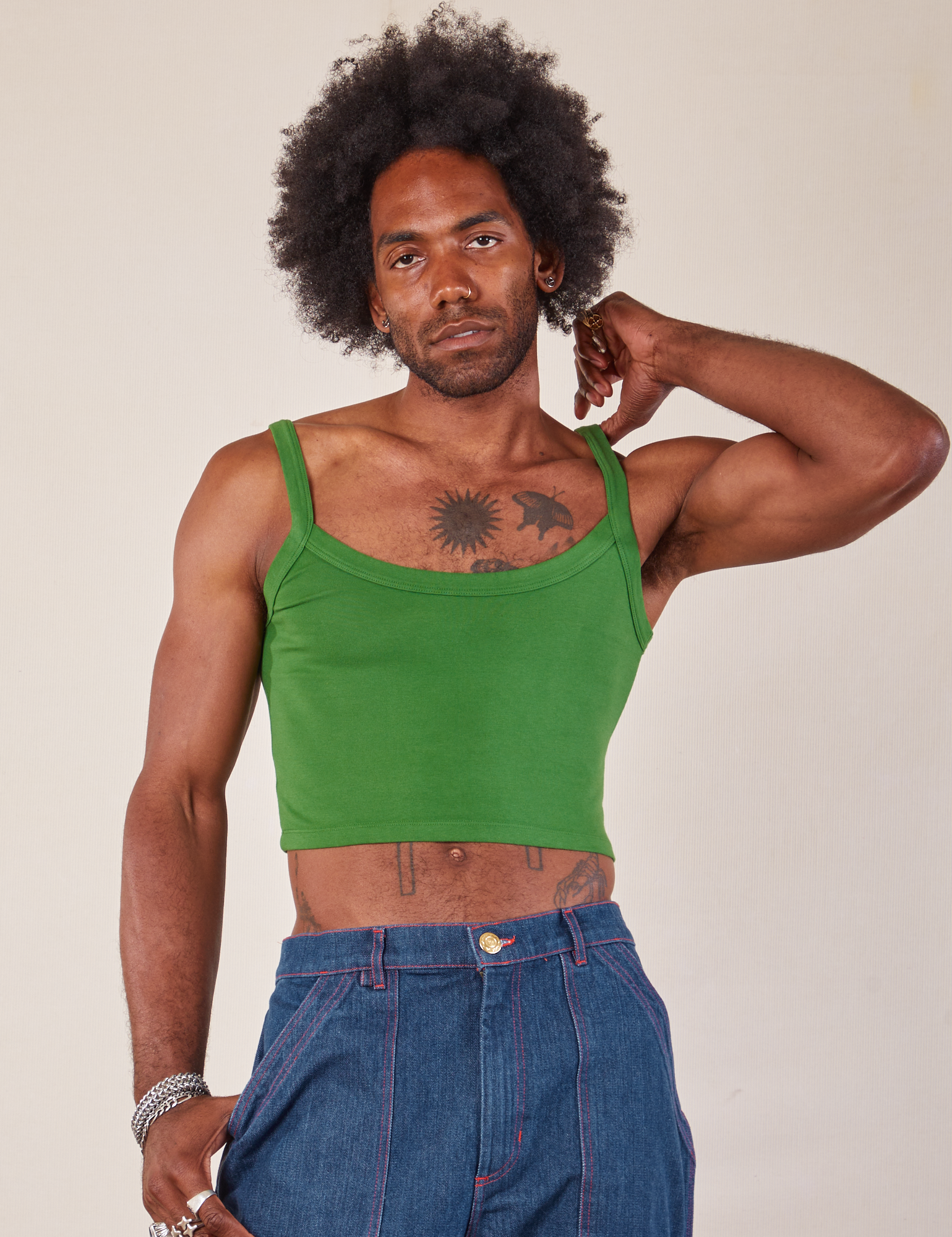 Jerrod is wearing Cropped Cami in Lawn Green and dark wash Carpenter Jeans