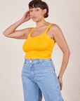 Angled view of Cropped Cami in Sunshine Yellow and light wash Sailor Jeans worn by Tiara