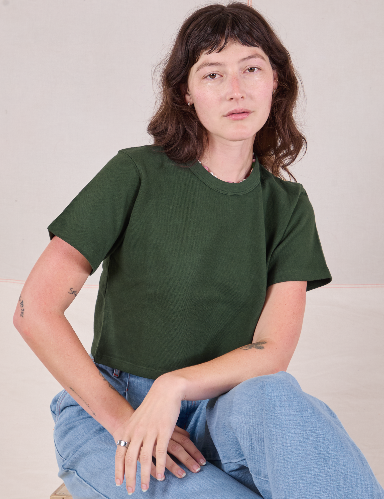 Alex is wearing Cropped Burly Tee in Swamp Green