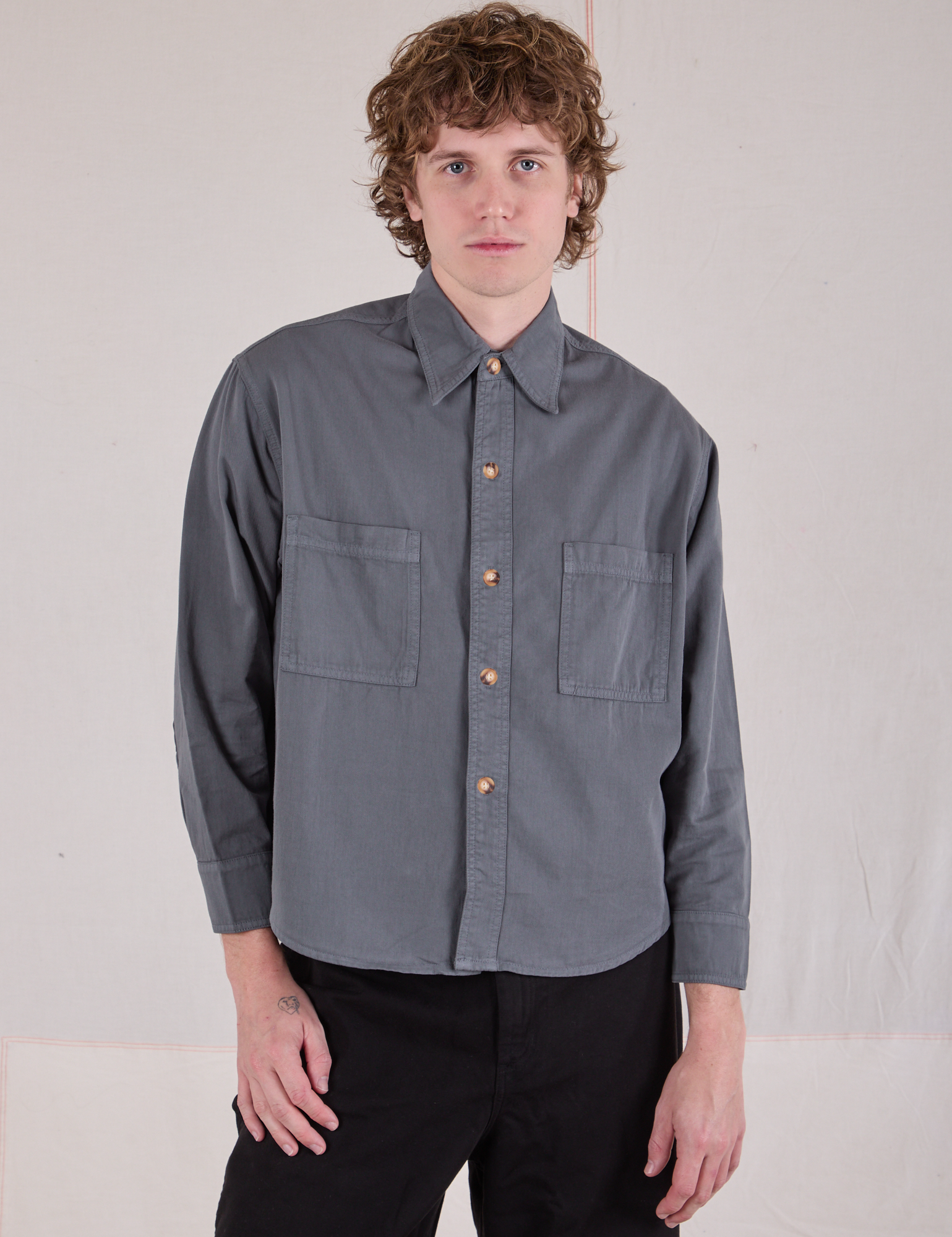 Quinn is wearing a buttoned up Cropped Overshirt in Slate Grey