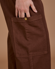 Close up of Drop Pocket Cargo Pants in Fudgesicle Brown side pant leg pocket on Alex