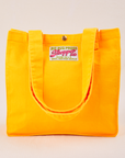 Shopper Tote Bag in Sunshine Yellow with straps hanging down front of bag