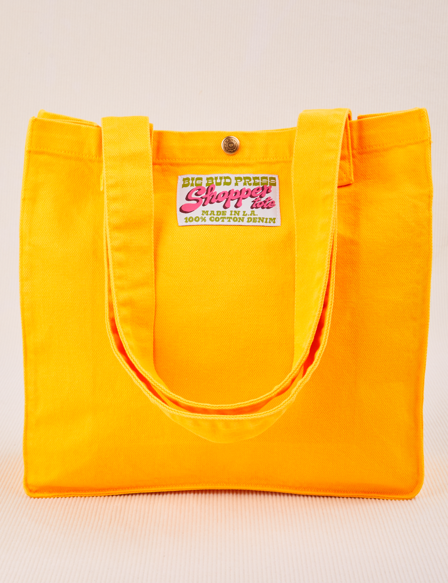 Shopper Tote Bag in Sunshine Yellow with straps hanging down front of bag