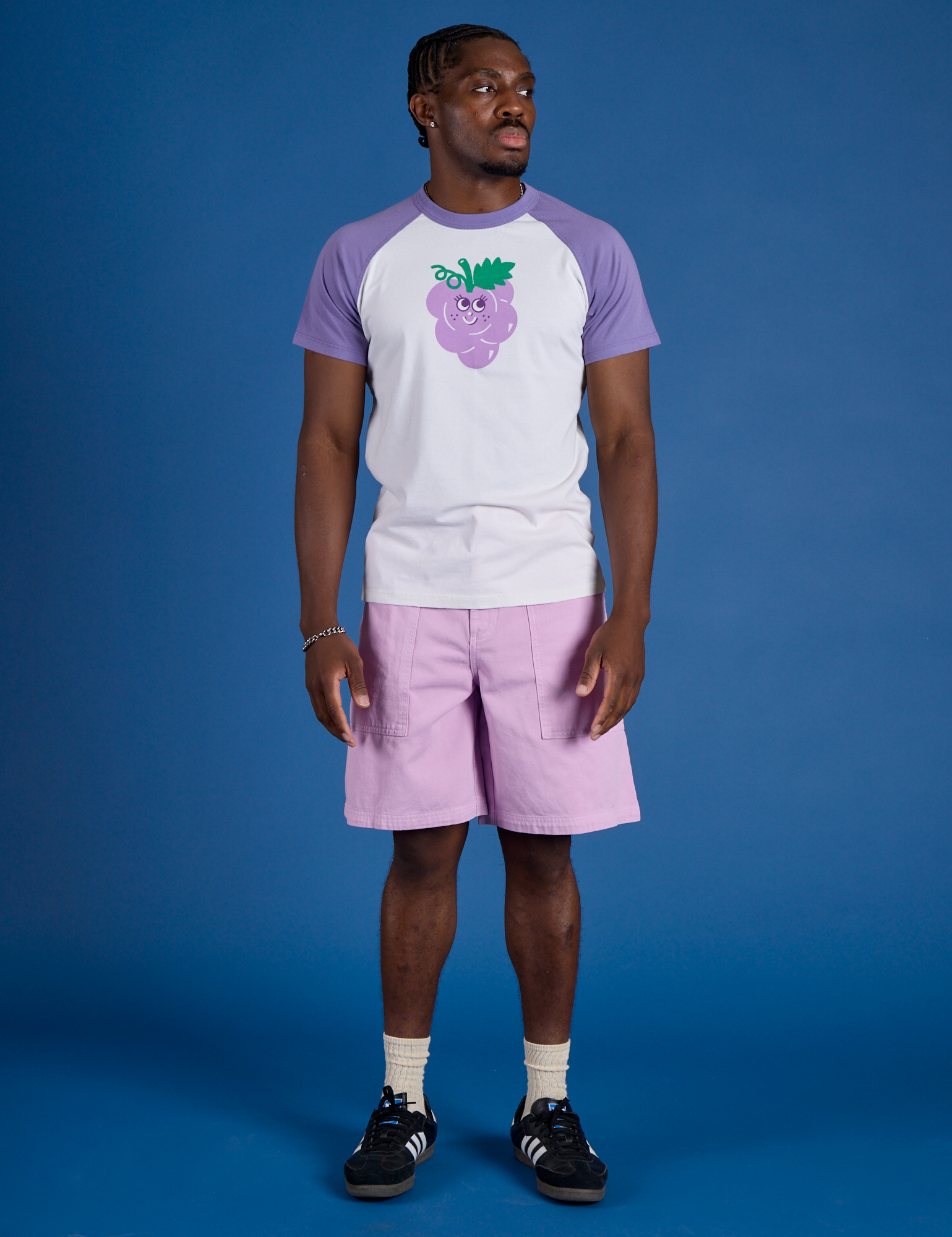 Isaac is wearing Produce Raglan Tee in Grape