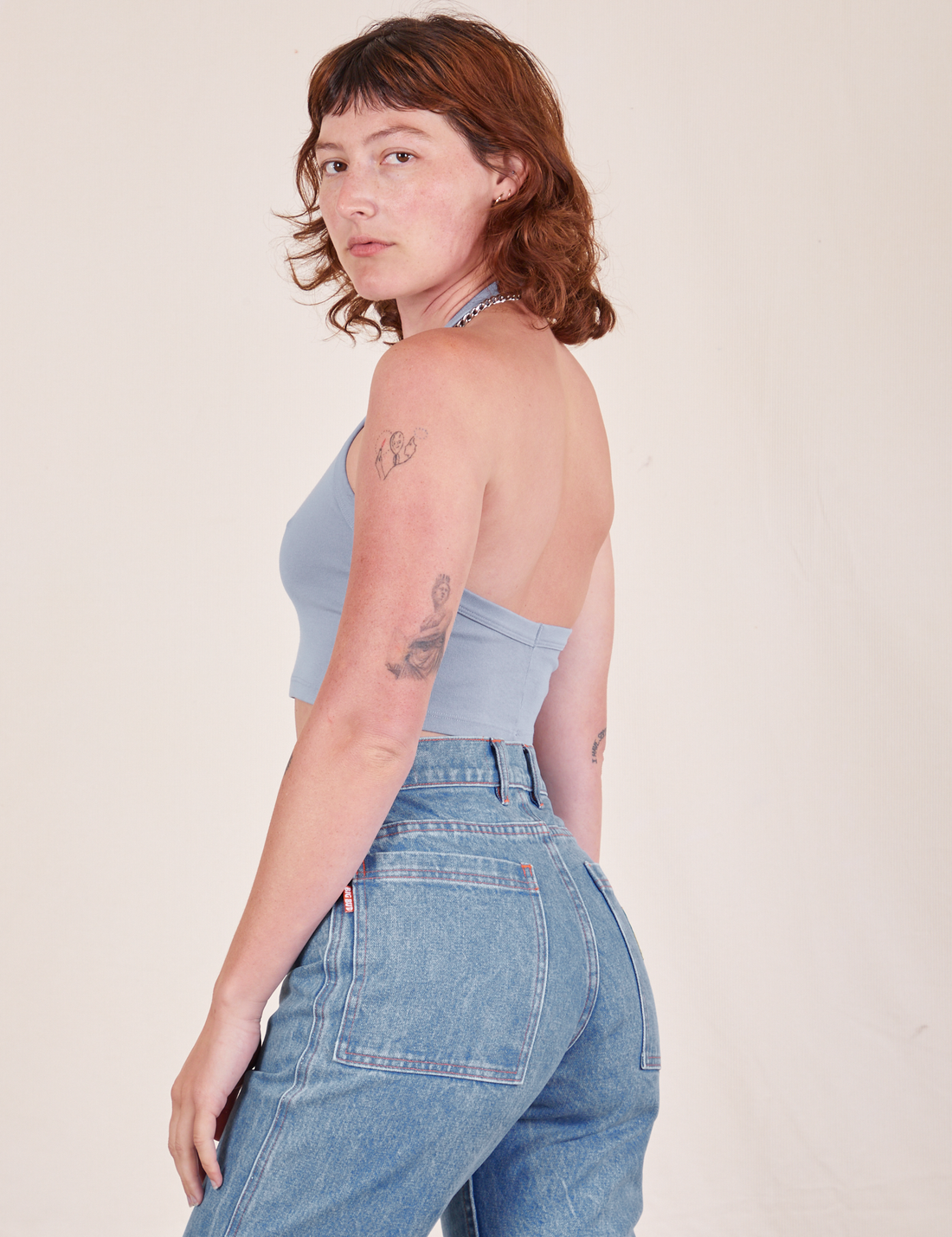 Side view of Halter Top in Periwinkle and light wash Frontier Jeans worn by Alex