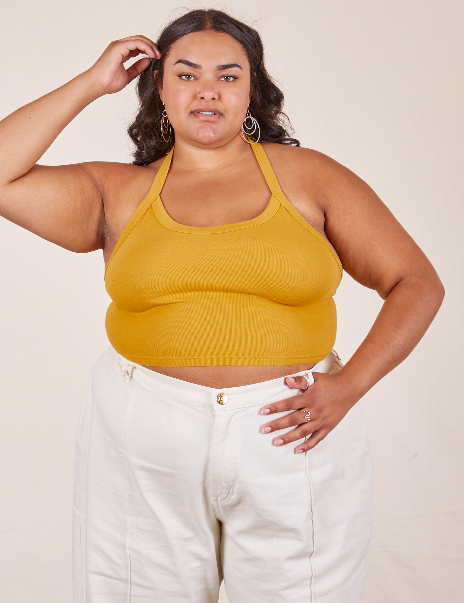 Alicia is 5&#39;9&quot; and wearing XL Halter Top in Mustard Yellow paired with vintage off-white Western Pants