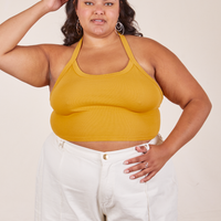 Alicia is 5'9" and wearing XL Halter Top in Mustard Yellow paired with vintage off-white Western Pants