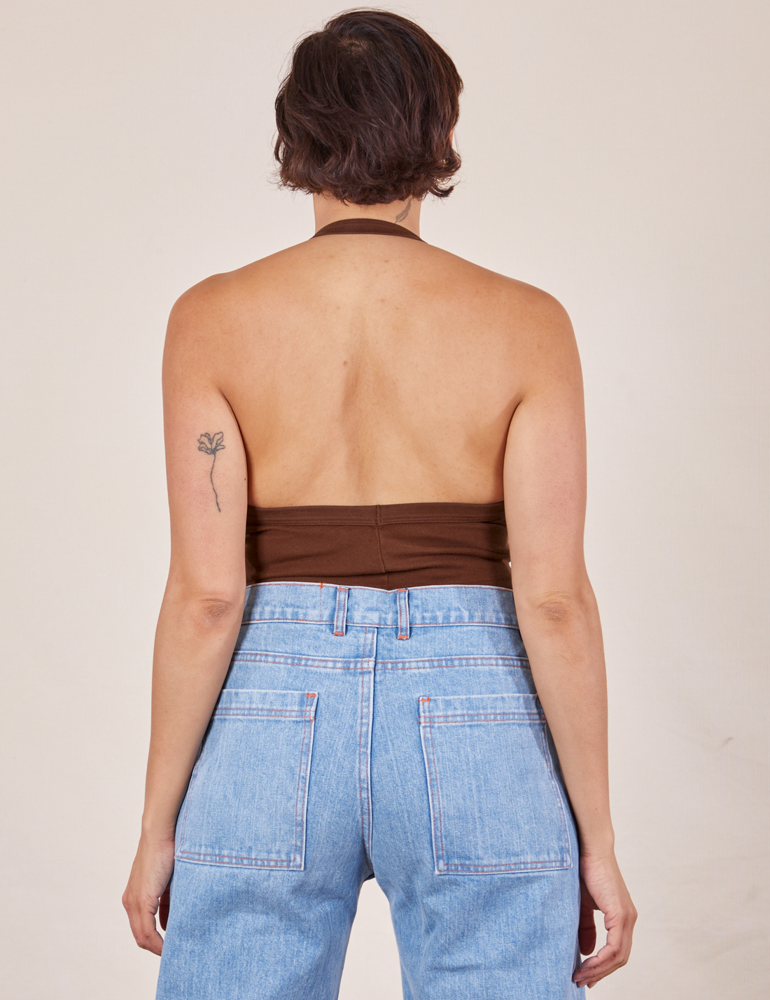Back view of Halter Top in Fudgesicle Brown and light wash Sailor Jeans worn by Tiara