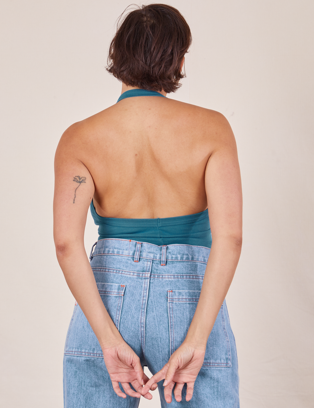 Back view of Halter Top in Marine Blue and light wash Sailor Jeans worn by Tiara