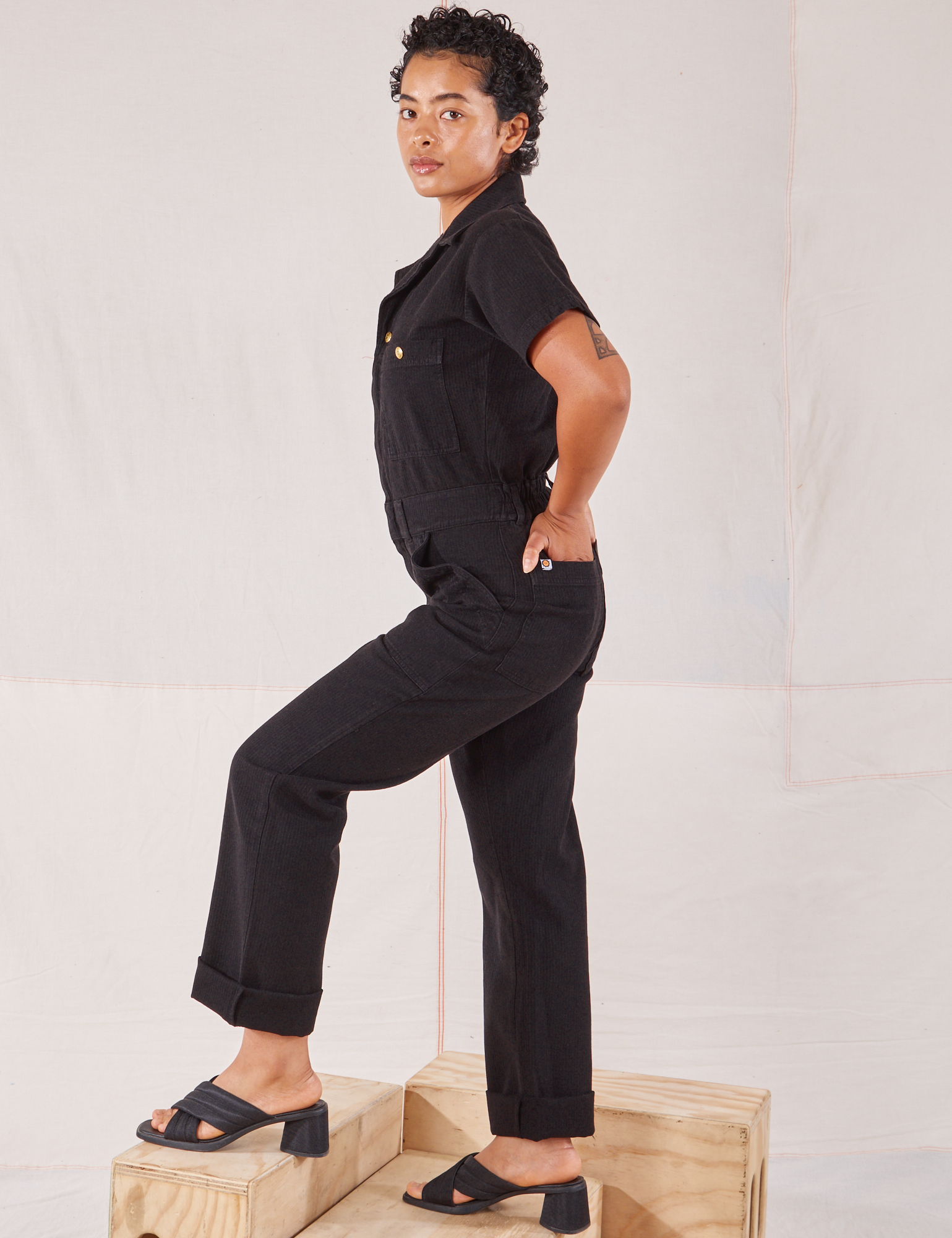 Heritage Short Sleeve Jumpsuit in Basic Black side view on Mika