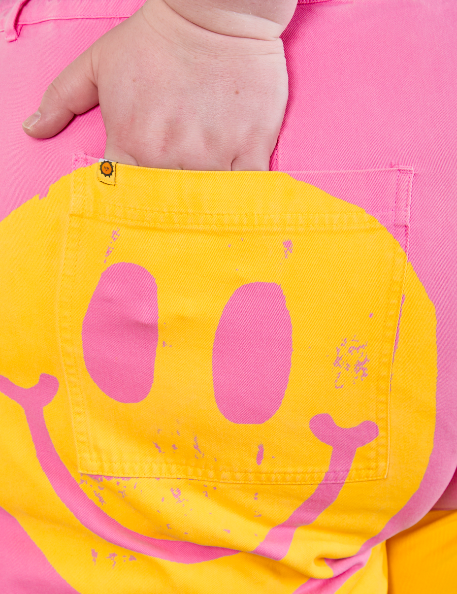 Back pocket close up of Icon Work Pants in Smilies. Catie has her hand in the pocket.