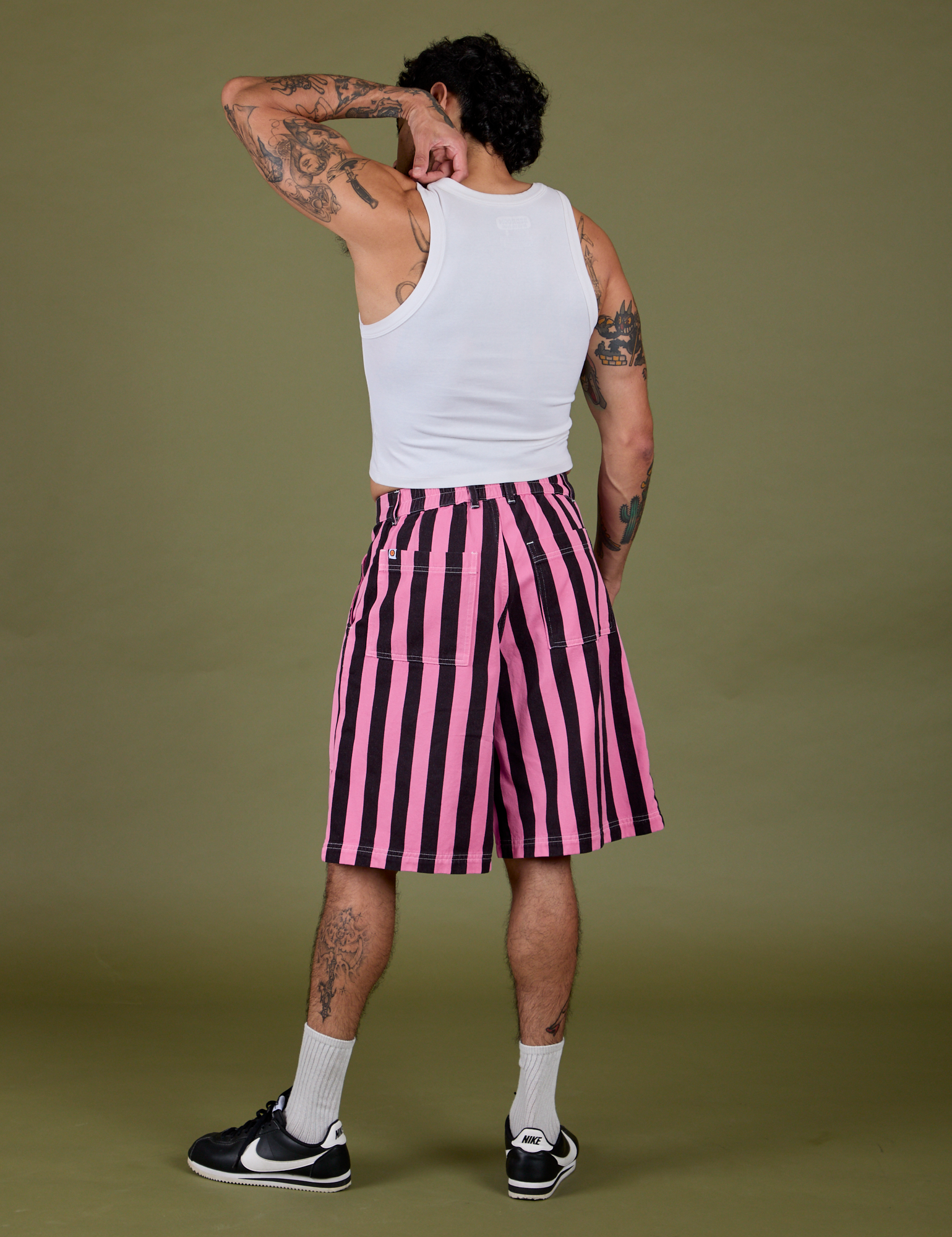 Back view of  Longline Work Shorts in Bubblegum Pink and vintage tee white Cropped Tank on Jesse