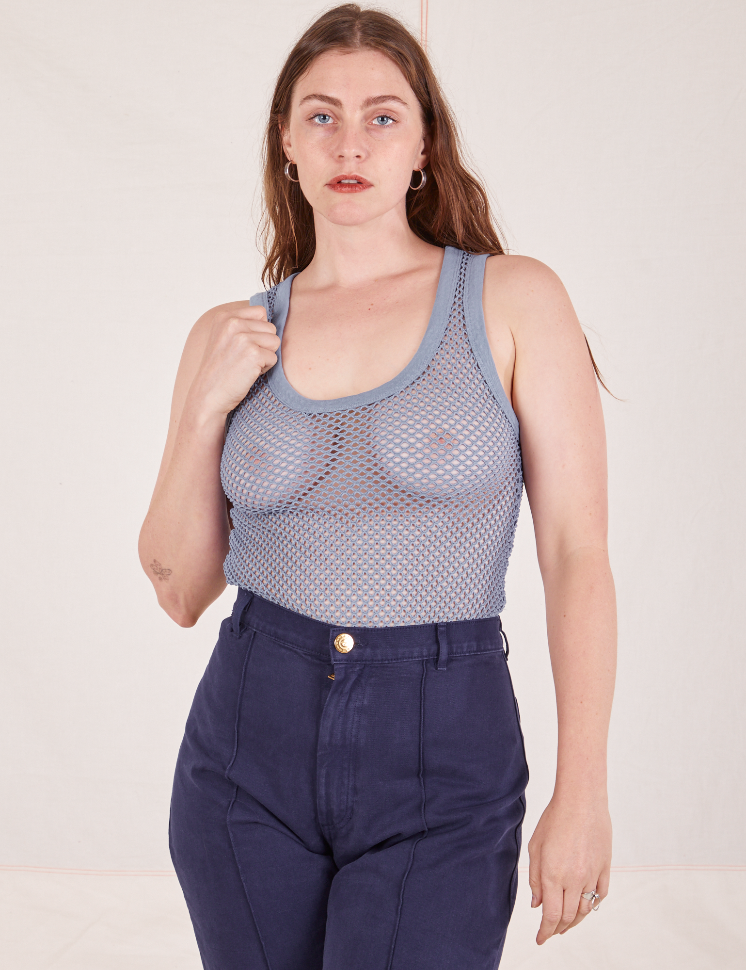 Allison is 5&#39;10 and wearing XXS Mesh Tank Top in Periwinkle paired with navy Western Pants