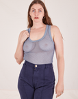 Allison is 5'10 and wearing XXS Mesh Tank Top in Periwinkle paired with navy Western Pants