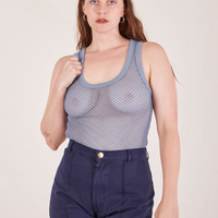 Allison is 5'10 and wearing XXS Mesh Tank Top in Periwinkle paired with navy Western Pants