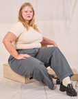 Juliet is wearing Mid-Rise Pleated Trousers in Slate Grey and Baby Tee in vintage tee off-white