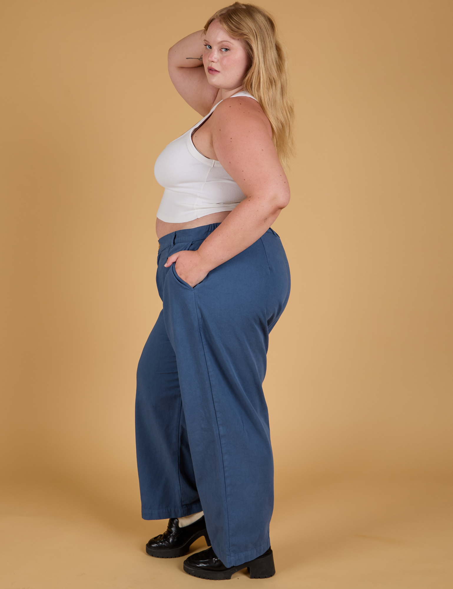Side view of Baggy Mid-Rise Trousers in French Blue and vintage tee white Cropped Tank on Juliet