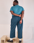 Back view of Mid-Rise Work Pants in Lagoon and marine blue Organic Vintage Tee on Elijah