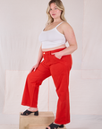 Side view of Mid-Rise Work Pants in Mustang Red and Cropped Cami in Vintage Tee Off-White on Lish