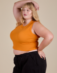 Angled front view of  Muscle Tee in Creamsicle Orange on Juliet