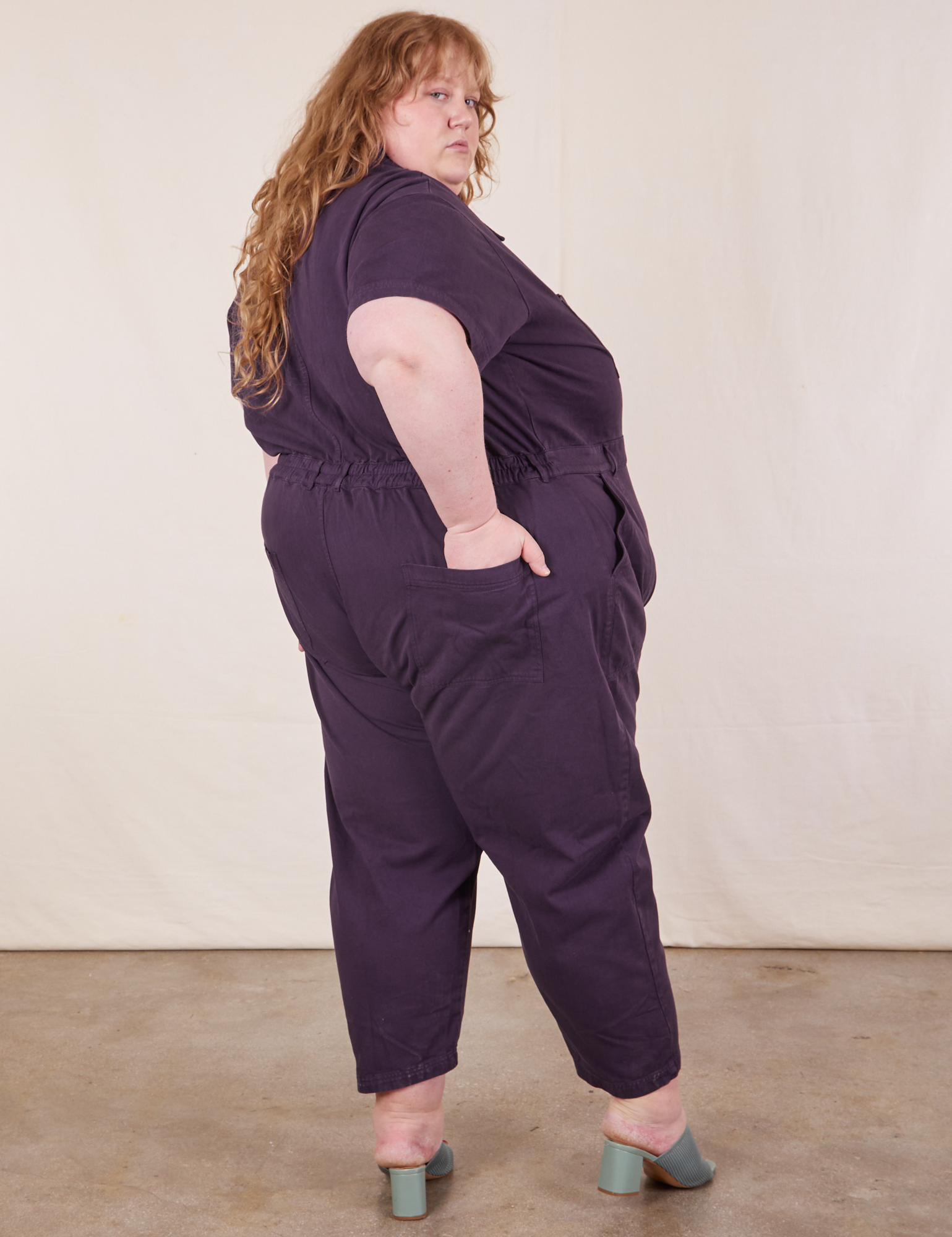 Side view of Short Sleeve Jumpsuit in Nebula Purple worn by Catie