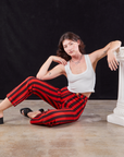 Alex is wearing Black Stripe Work Pants in Mustang Red and Cropped Tank in vintage tee off-white