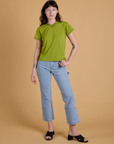 Alex is wearing Organic Vintage Tee in Gross Green and light wash Carpenter Jeans