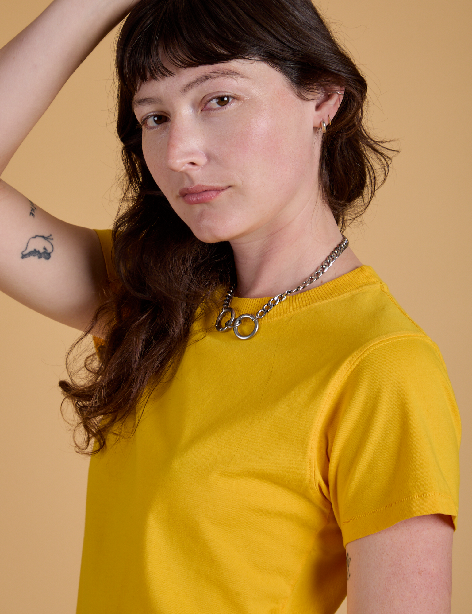 Angled front view close up of Organic Vintage Tee in Sunshine Yellow on Alex