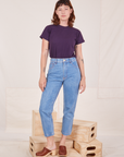 Alex is wearing The Organic Vintage Tee in Nebula Purple tucked into light wash Frontier Jeans