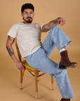 Jesse is wearing Organic Vintage Tee in Vintage Off White and light wash Carpenter Jeans