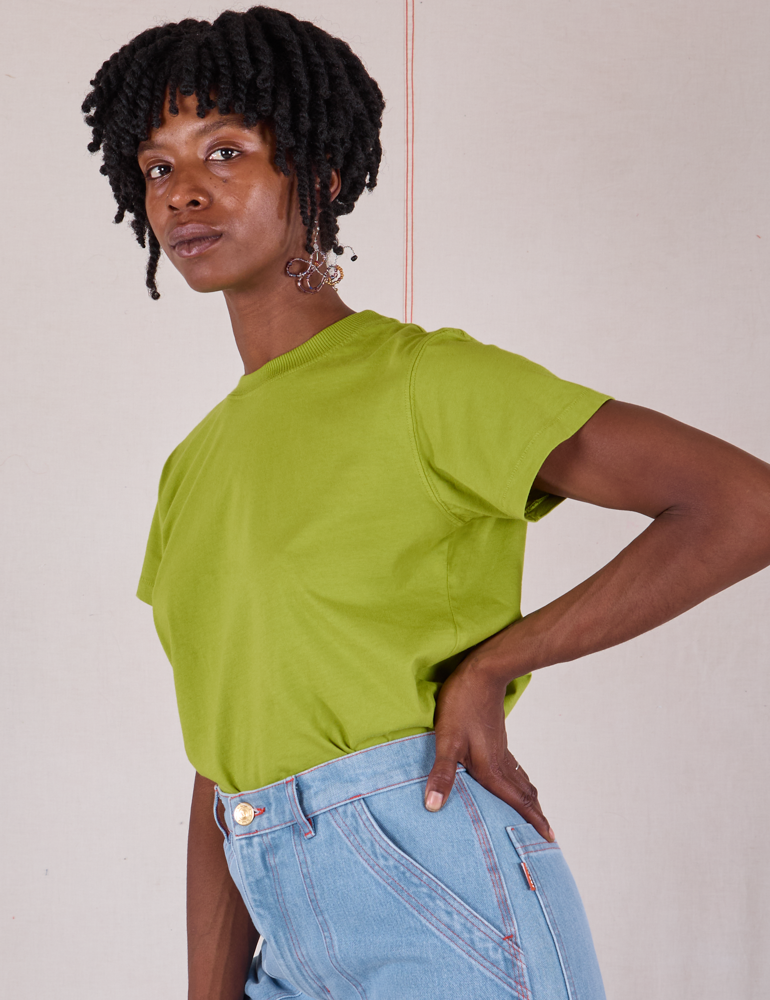 Angled front view of Organic Vintage Tee in Gross Green on Cheyann