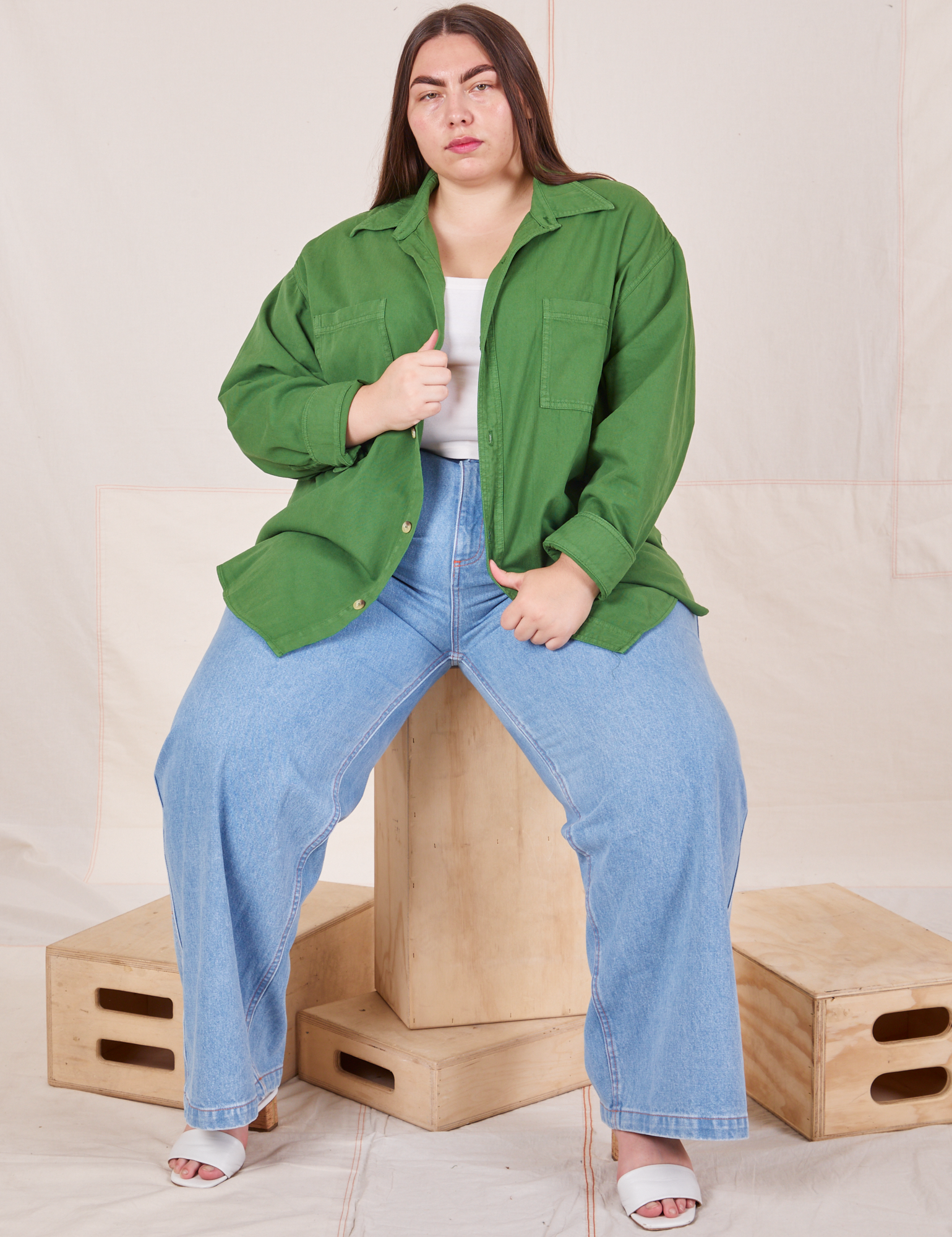 Marielena is wearing Oversize Overshirt in Lawn Green, vintage off-white Cropped Tank Top and light wash Sailor Jeans