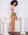 Side view of Hand-Painted Stripe Western Pants in Bright Olive and vintage off-white Tank Top. Pink and orange hand painted stripe along the side of the pant