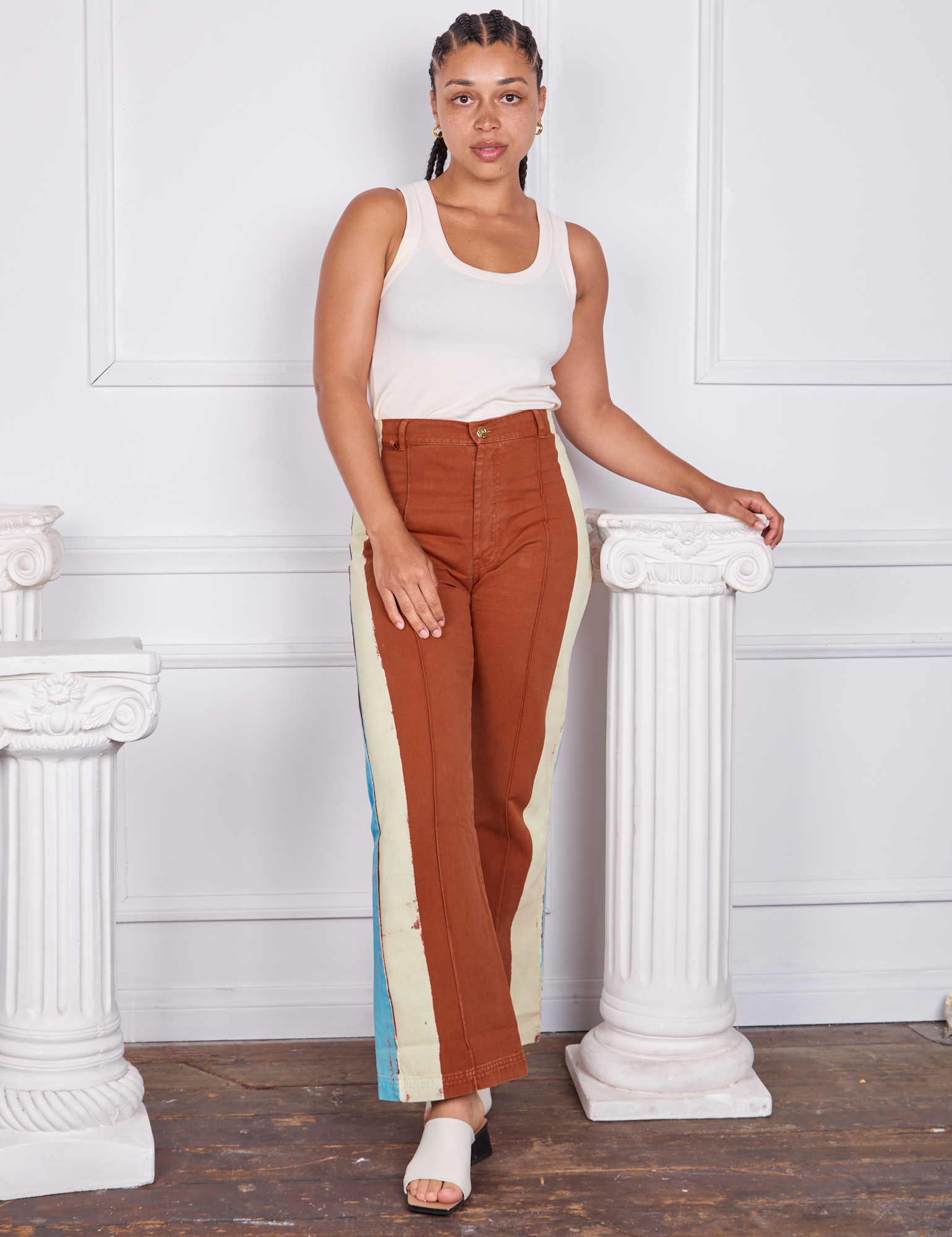 Gabi is wearing Hand-Painted Stripe Western Pants in Burnt Terracotta and a vintage off-white Tank Top
