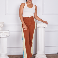Gabi is wearing Hand-Painted Stripe Western Pants in Burnt Terracotta and a vintage off-white Tank Top