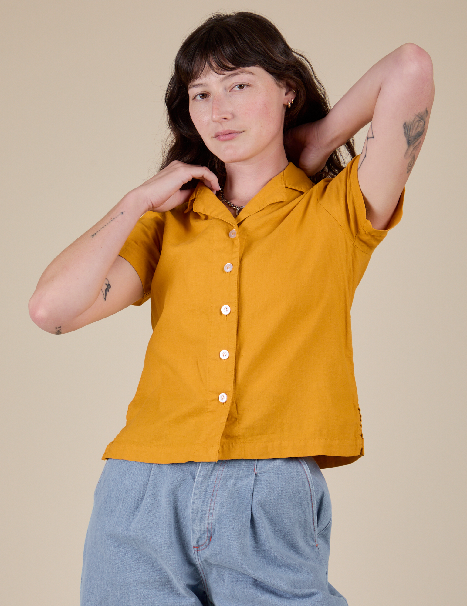 Alex is 5’8” and wearing P Pantry Button-Up in Mustard Yellow