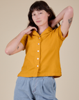 Alex is 5’8” and wearing P Pantry Button-Up in Mustard Yellow