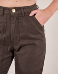 Pencil Pants in Espresso Brown front pocket close up. Scarlett has her hand in the pocket.