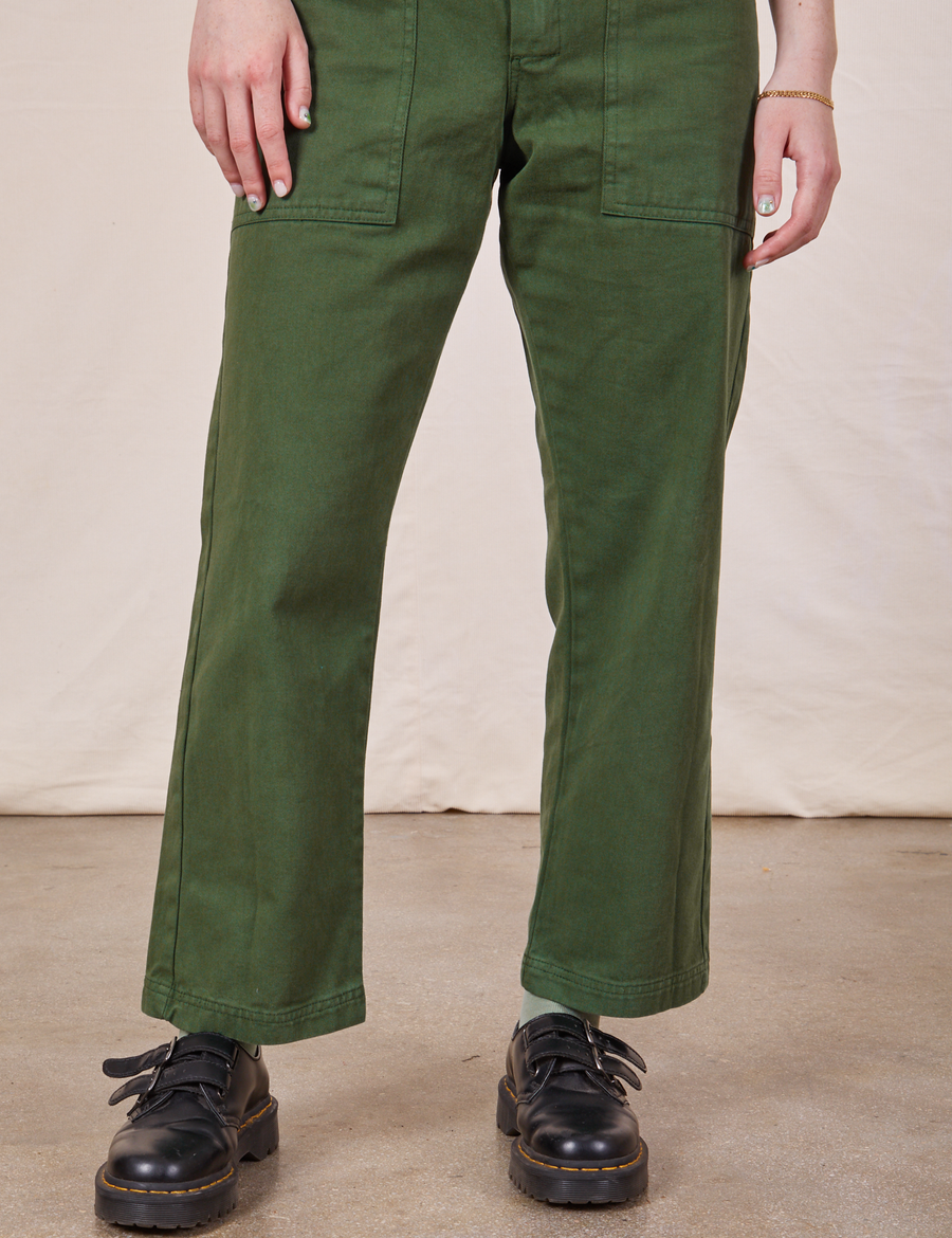 Pant leg close up of Petite Short Sleeve Jumpsuit in Dark Emerald Green worn by Hana