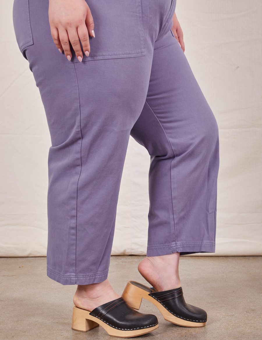 Pant leg close up side view of Petite Short Sleeve Jumpsuit in Faded Grape worn by Ashley