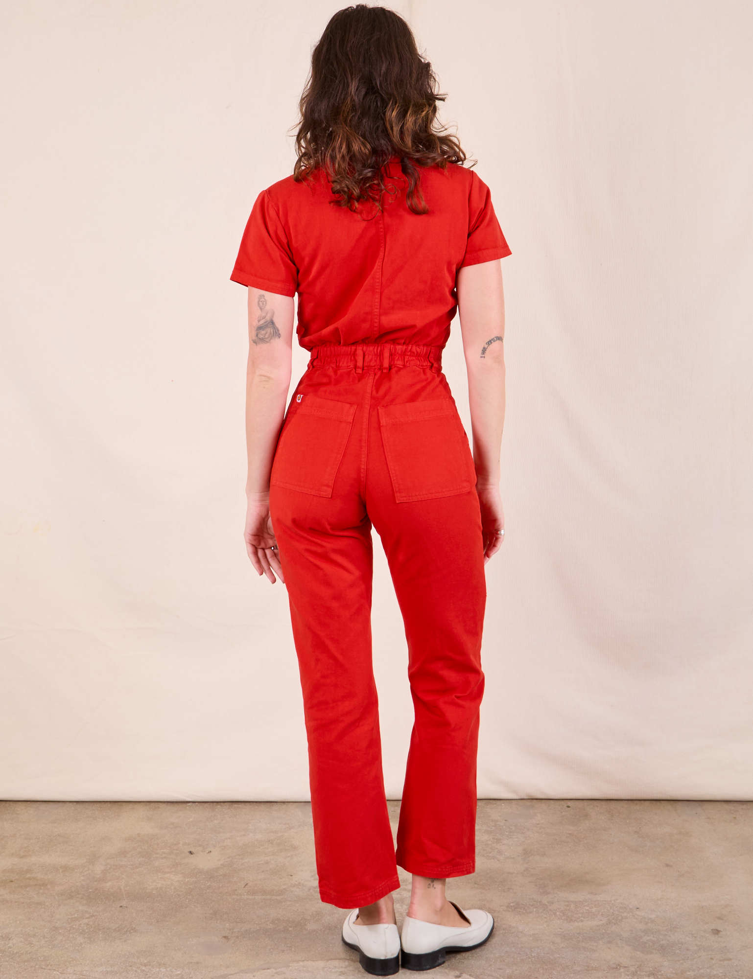 Short Sleeve Jumpsuit in Mustang Red back view on Alex