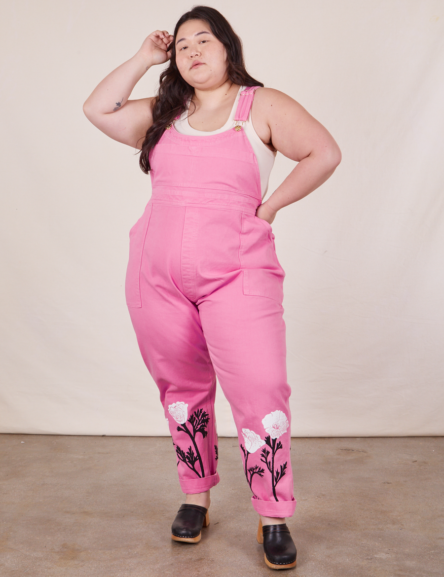 Ashley is 5'7" and wearing 1XL California Poppy Overalls in Bubblegum Pink with a vintage off-white Tank Top underneath.