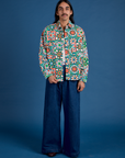 Anthony is 5’6” and wearing S Cropped Overshirt in Quilt Print paired with dark wash Indigo Wide Leg Trousers