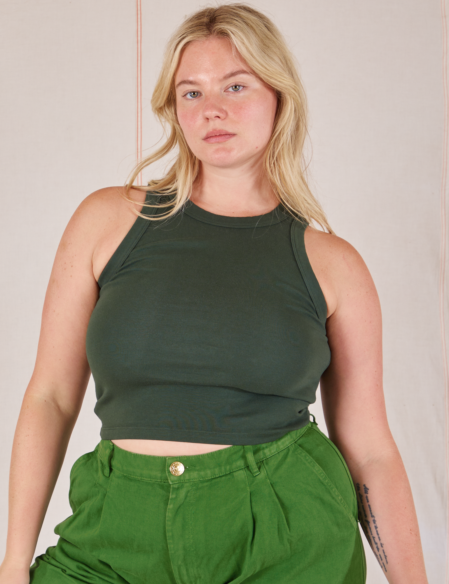 Lish is 5’8” and wearing L Racerback Tank in Swamp Green