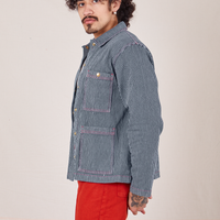 Side view of Railroad Stripe Denim Work Jacket paired with paprika Western Pants worn by Jesse