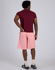 Back view of Longline Work Shorts in Baby Pink and red wine Organic Vintage Tee on Isaac
