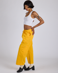 Side view of Drop Pocket Cargo Pants in Sunshine Yellow and Cropped Tank in Vintage Tee White on Kira