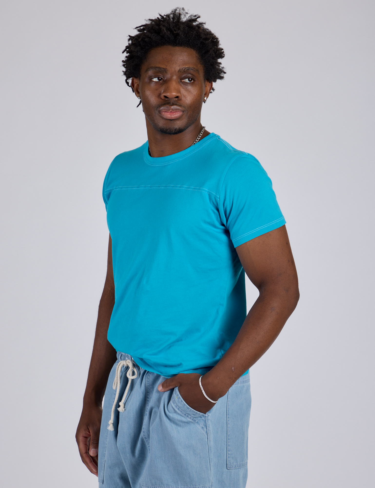 Jr. Varsity Tee in Hawaiian Blue angled front view on Isaac