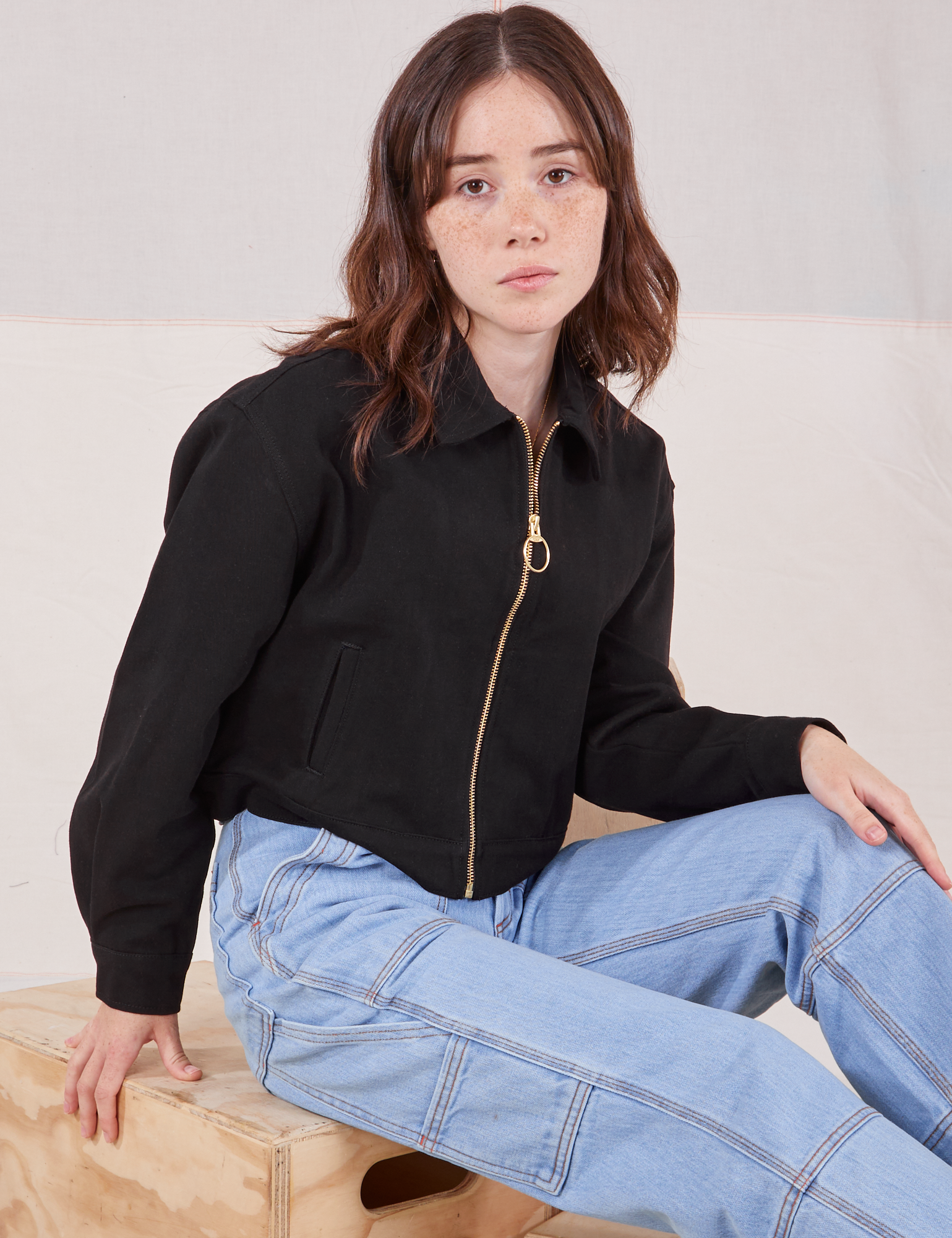 Hana is wearing Ricky Jacket in Basic Black and light wash Carpenter Jeans